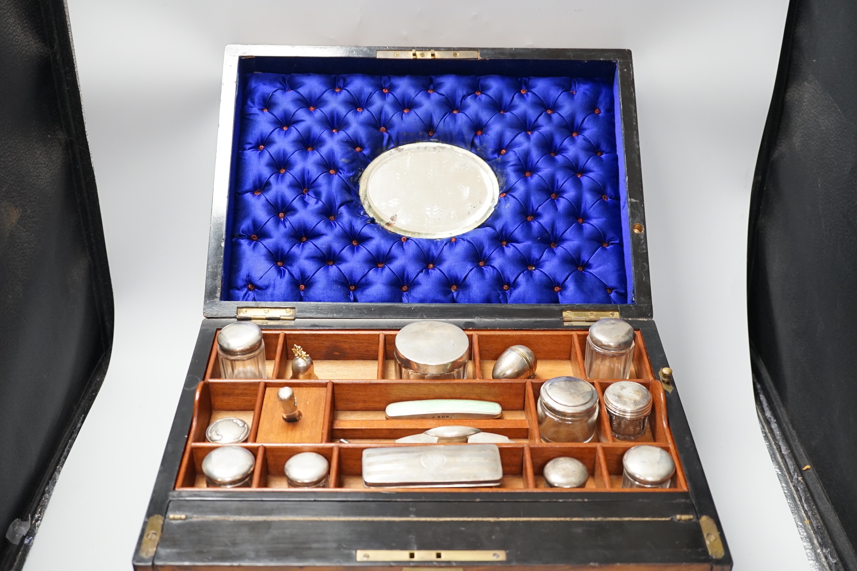 A Victorian combination walnut writing and toilet box, containing various silver lidded glass jars, inset bevelled mirror and other accessories, 40.5cm x 28.5cm x 24.5cm